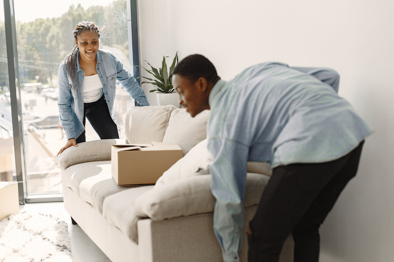 furniture pick-up and delivery services. The scenes show delivery trucks with company logos, parked in front of houses, with furniture items being loaded or unloaded by workers in uniforms.